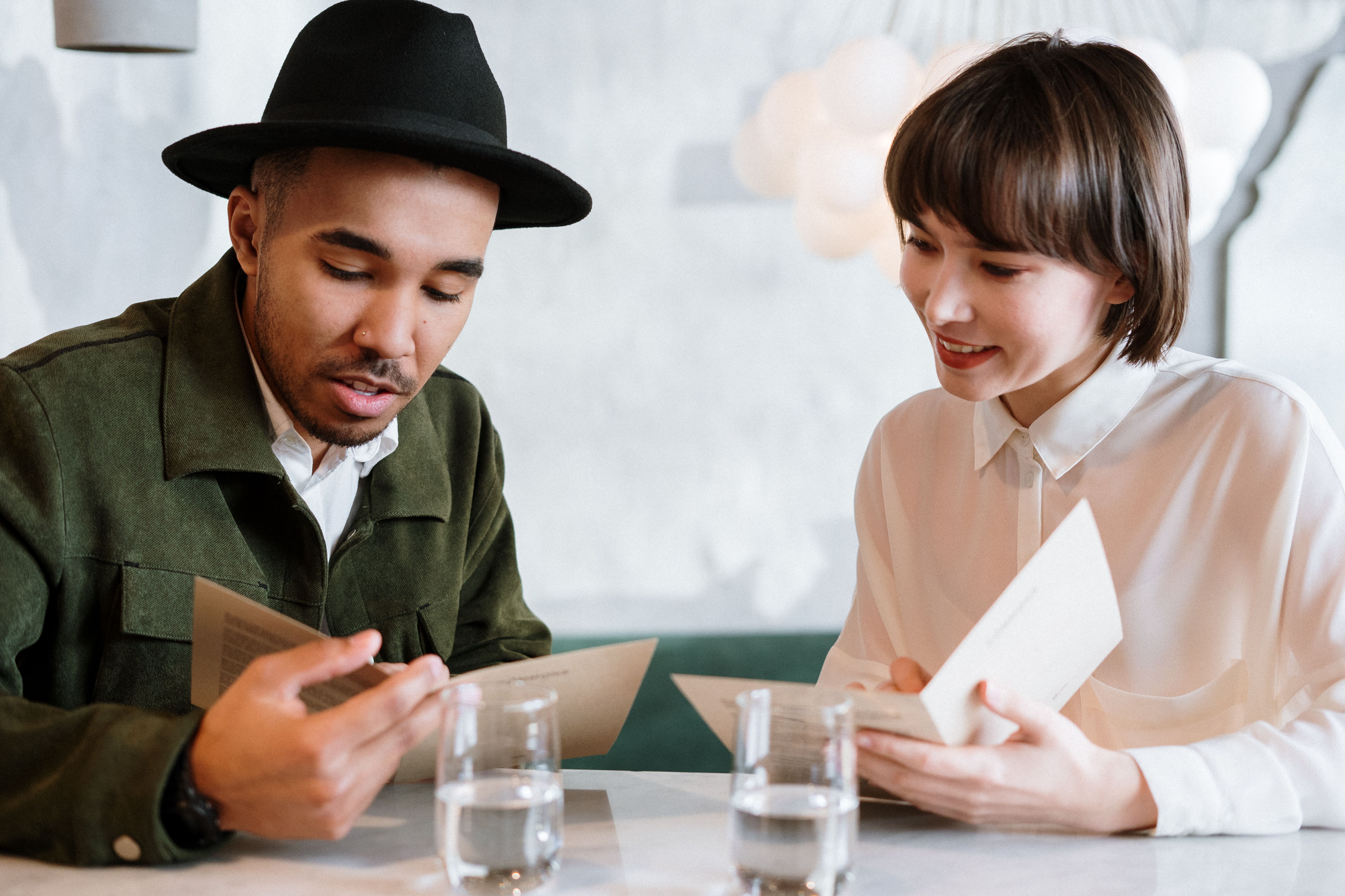 Couple browsing menus together at a cafe table