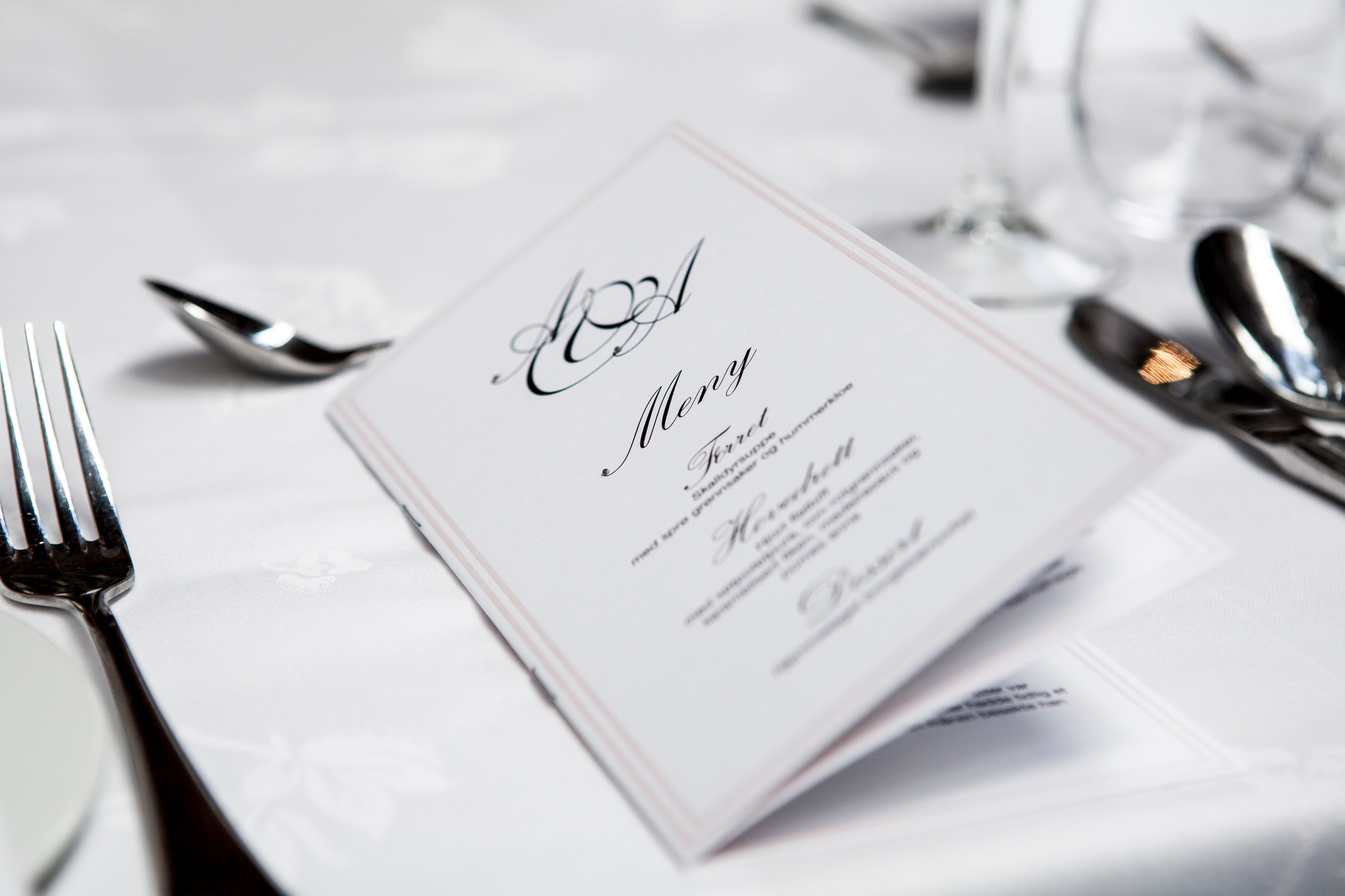 Elegant dining table arranged with a menu and silverware